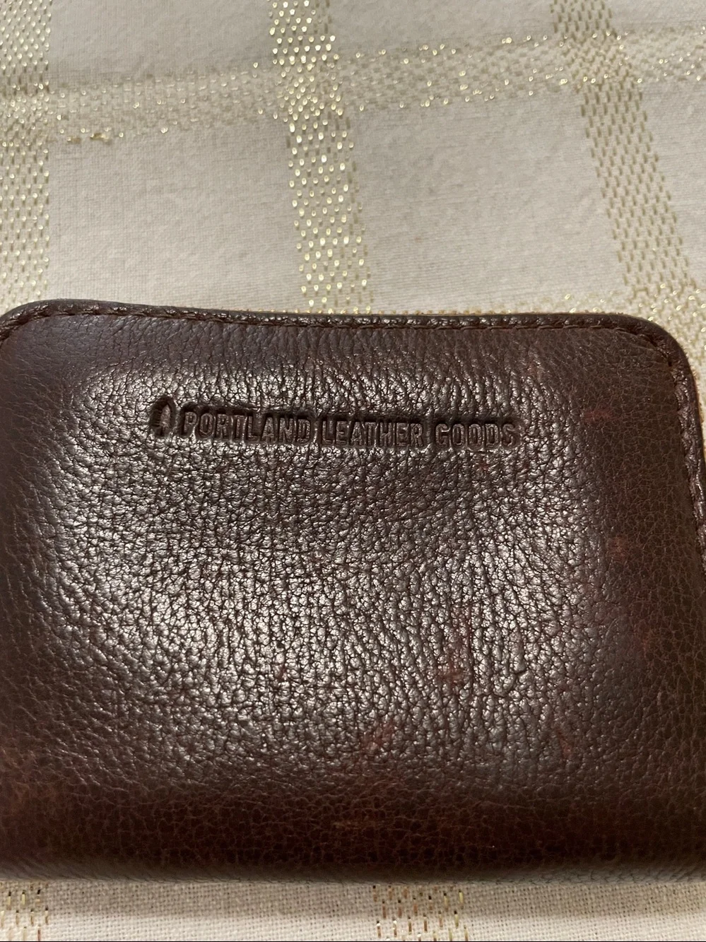 Portland Leather Goods brown wallet, gold tone zipper, inside holds coins/cards